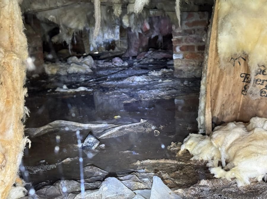 Charlotte NC crawl space with standing water and soaked insulation after an unaddressed leak